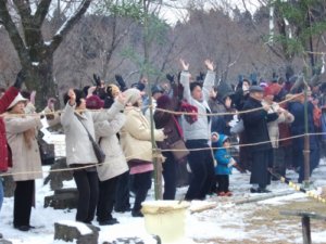 雪の中で盛り上がる参拝客